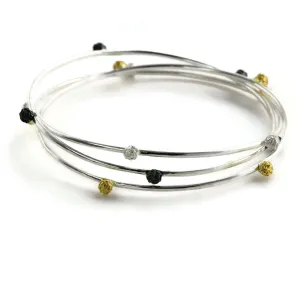 A Set of three bangles, with stellar peppercorns design accented with gold vermiel, dark and bright silver sterling