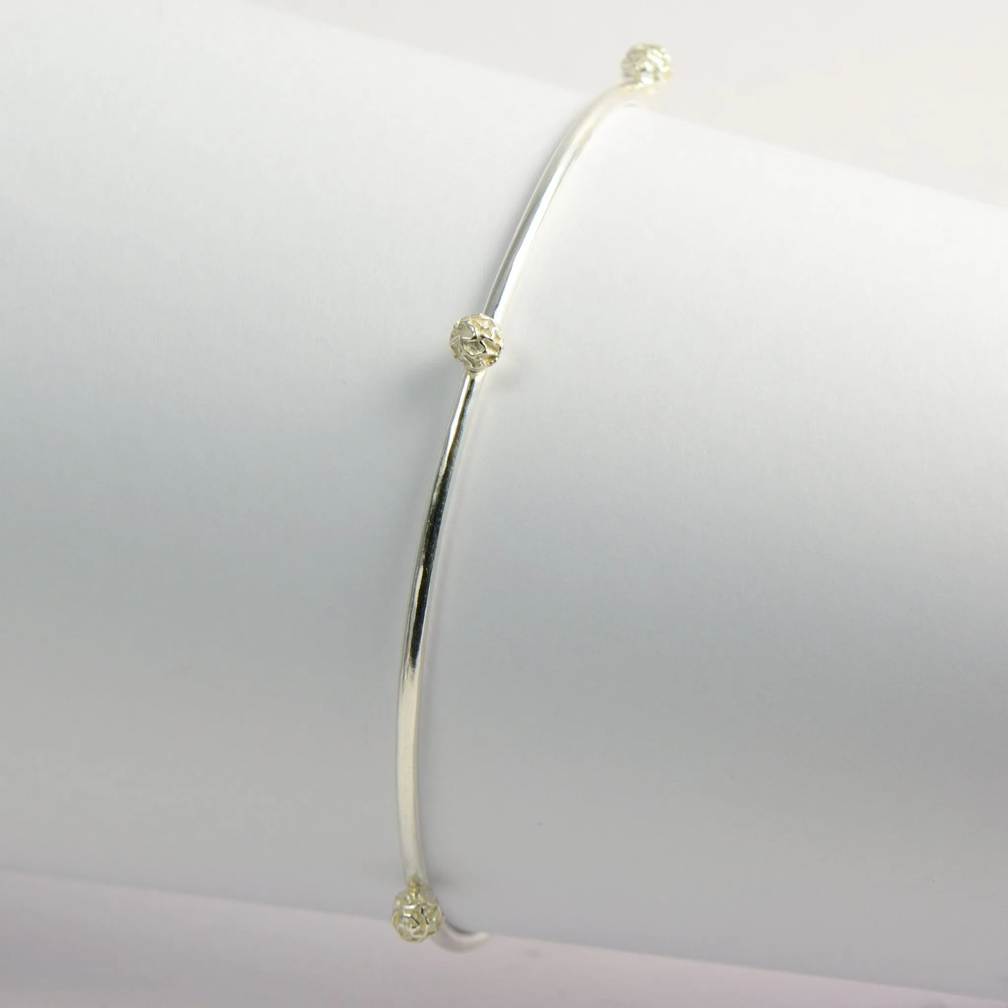 A Set of three bangles, with stellar peppercorns design accented with gold vermiel, dark and bright silver sterling